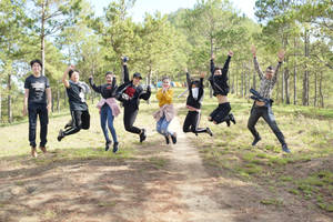 Group Of People Jumping In The Forest Wallpaper