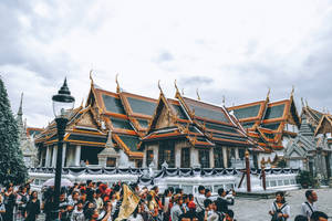 Group Of People Outside A Temple Wallpaper