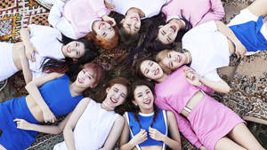 Group Twice Lying On Carpet Wallpaper