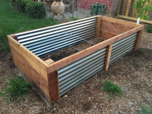 Growing Vegetables In A Garden Bed Filled With Nutrient-rich Soil Wallpaper