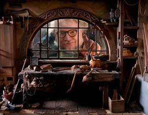 Guillermo Del Toro's Pinocchio Sitting Atop A Circus Caravan In The Moonlight Wallpaper