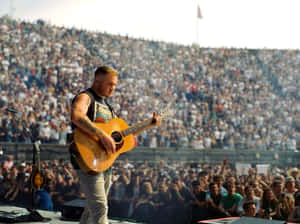 Guitarist Performing Liveat Concert Wallpaper