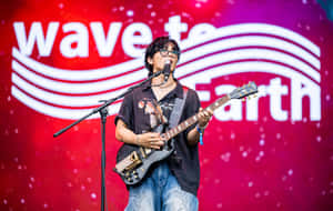 Guitarist Performingat Wave To Earth Festival Wallpaper