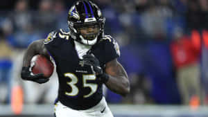 Gus Edwards Ravens Running Back Action Wallpaper