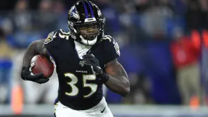 Gus Edwards Ravens Running Back Action Wallpaper