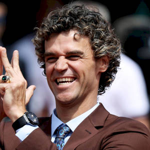 Gustavo Kuerten Smiling In Brown Suit Wallpaper