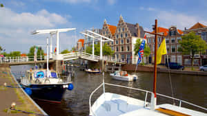 Haarlem River Viewwith Bridgeand Boats Wallpaper