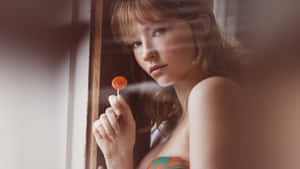 Haley Bennett Holding Lollipop Wallpaper