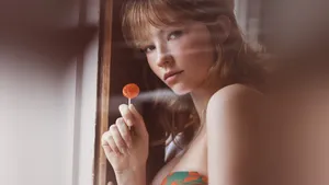 Haley Bennett Holding Lollipop Wallpaper
