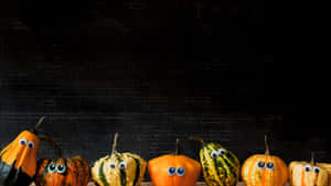 Halloween Pumpkinswith Googly Eyes Wallpaper