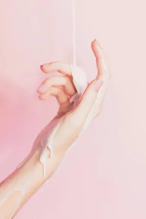 Hand Cream Pour Pink Background Wallpaper