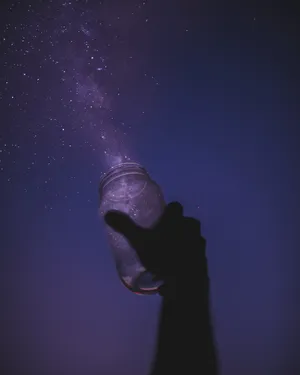 Hand Holding Glass Bottle Lucid Wallpaper