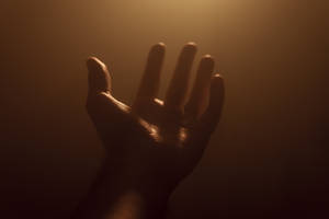 Hand On Dim Light Wallpaper