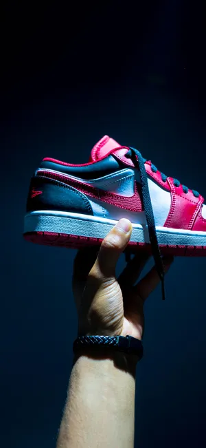 Handheld Sneaker Spotlight Wallpaper