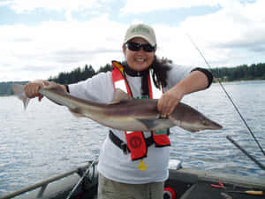 Happy Anglerwith Dogfish Catch Wallpaper