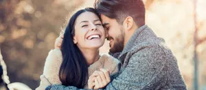 Happy Couple Embracing Outdoors Wallpaper