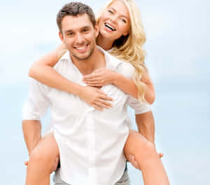 Happy Couple Piggyback Fun Wallpaper