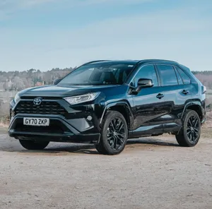 Happy Family Enjoying A Road Trip In Their Family Car Wallpaper
