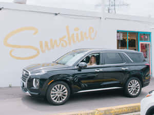 Happy Family Enjoying A Road Trip In Their Stylish Family Car Wallpaper