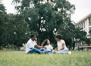 Happy Family In Grass Wallpaper