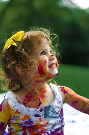 Happy Infant Playing With Plush Toy Wallpaper