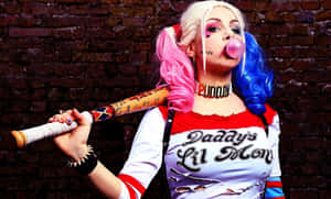 Harley Quinn Holding Her Iconic Baseball Bat In A Powerful Stance Wallpaper