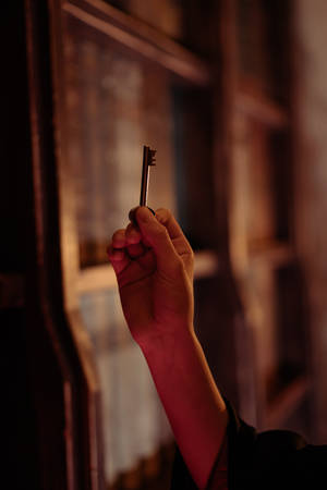 Harry Potter Aesthetic Hand Holding A Key Wallpaper