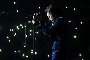 Harry Styles Playing On His Laptop Wallpaper