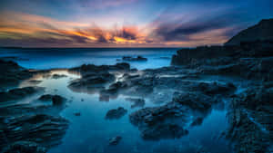 Hawaiian Sunset Over Rocky Shore Wallpaper