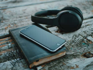 Headphones Smartphone Notebookon Wooden Table Wallpaper