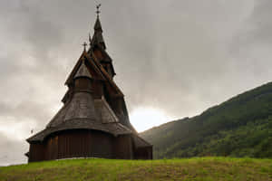 Heddal Stave Church With Peeking Sun Wallpaper