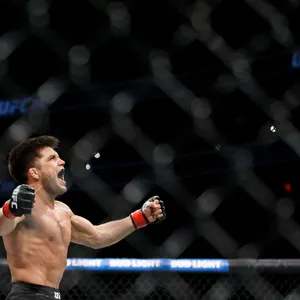 Henry Cejudo Celebrating Victory Over Tj Dillashaw Wallpaper