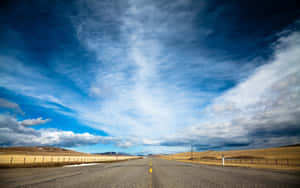 Hi Res Sky Over An Empty Road Wallpaper