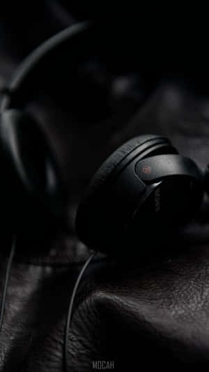 High-end Gaming Headphones On A Desktop Wallpaper