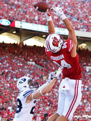 High Flying Football Catch Wallpaper