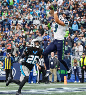 High Flying Football Catch Wallpaper