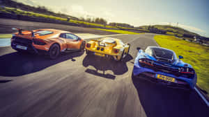 High-octane Supercar Race In Action Wallpaper