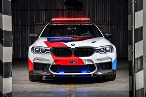 High-performance Safety Car Speeding On The Racing Track Wallpaper