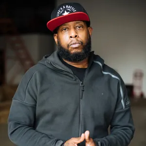 Hip Hop_ Artist_in_ Black_ Hoodie_and_ Cap Wallpaper