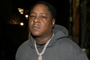 Hip Hop_ Artist_in_ Grey_ Hoodie Wallpaper