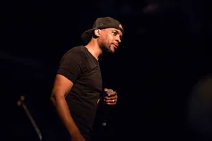 Hip Hop Artist Performanceon Stage Wallpaper