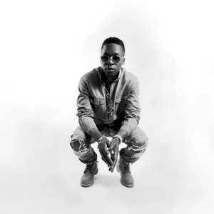 Hip Hop Artist Squatting Pose Wallpaper