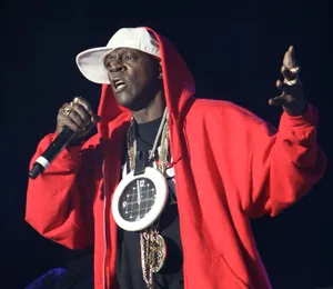 Hip Hop Artist With Clock Necklace_ Performance Wallpaper