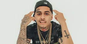 Hip Hop_ Artist_with_ Tattoos_and_ Gold_ Chains.jpg Wallpaper