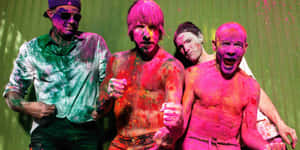 Holi Festival - A Group Of Men With Paint On Their Faces Wallpaper