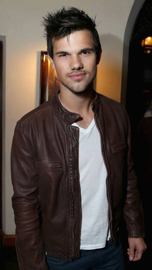 Hollywood Actor Taylor Lautner Donning A Leather Jacket Wallpaper