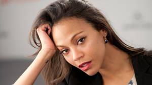 Hollywood Actress Zoe Saldana Showcasing A Neutral Expression. Wallpaper