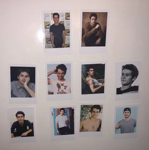 Hollywood Star Dylan O'brien Posing With Polaroid Pictures Wallpaper
