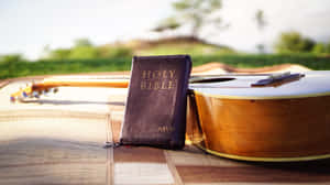 Holy Bible On Brown Guitar Wallpaper