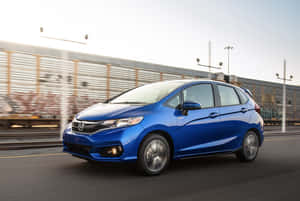 Honda Fit Parked In An Urban Setting Wallpaper